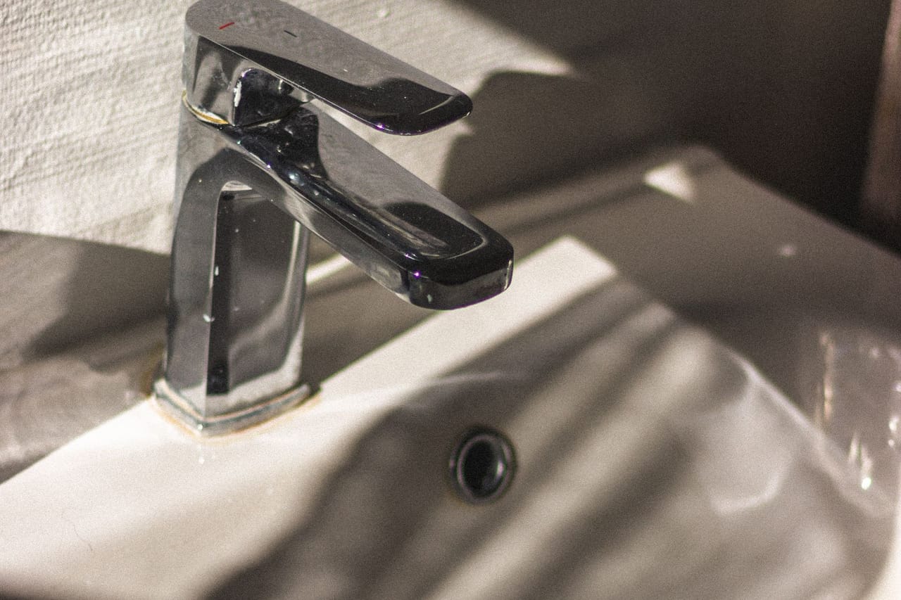 Plumber Fort Worth TX: Stainless steel faucet and sink in sunlight