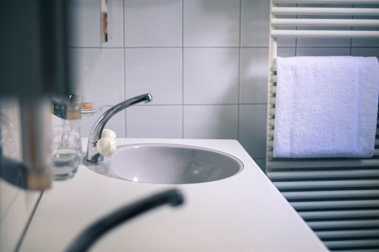 Plumber Fremont CA: A bathroom sink near a towel rack