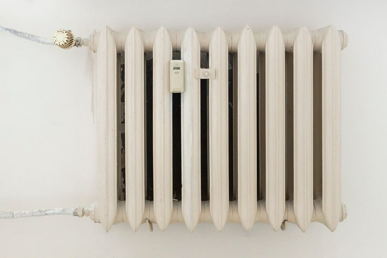 Plumber Frisco TX: White steel rib radiator in a new bright renovated room