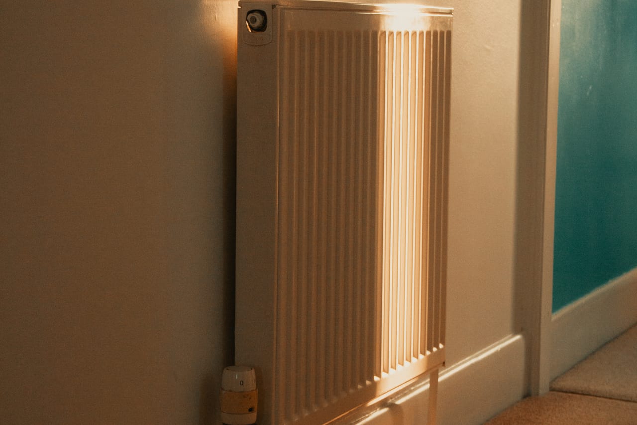 Plumber Garland TX: Sunlit radiator in a cozy home interior