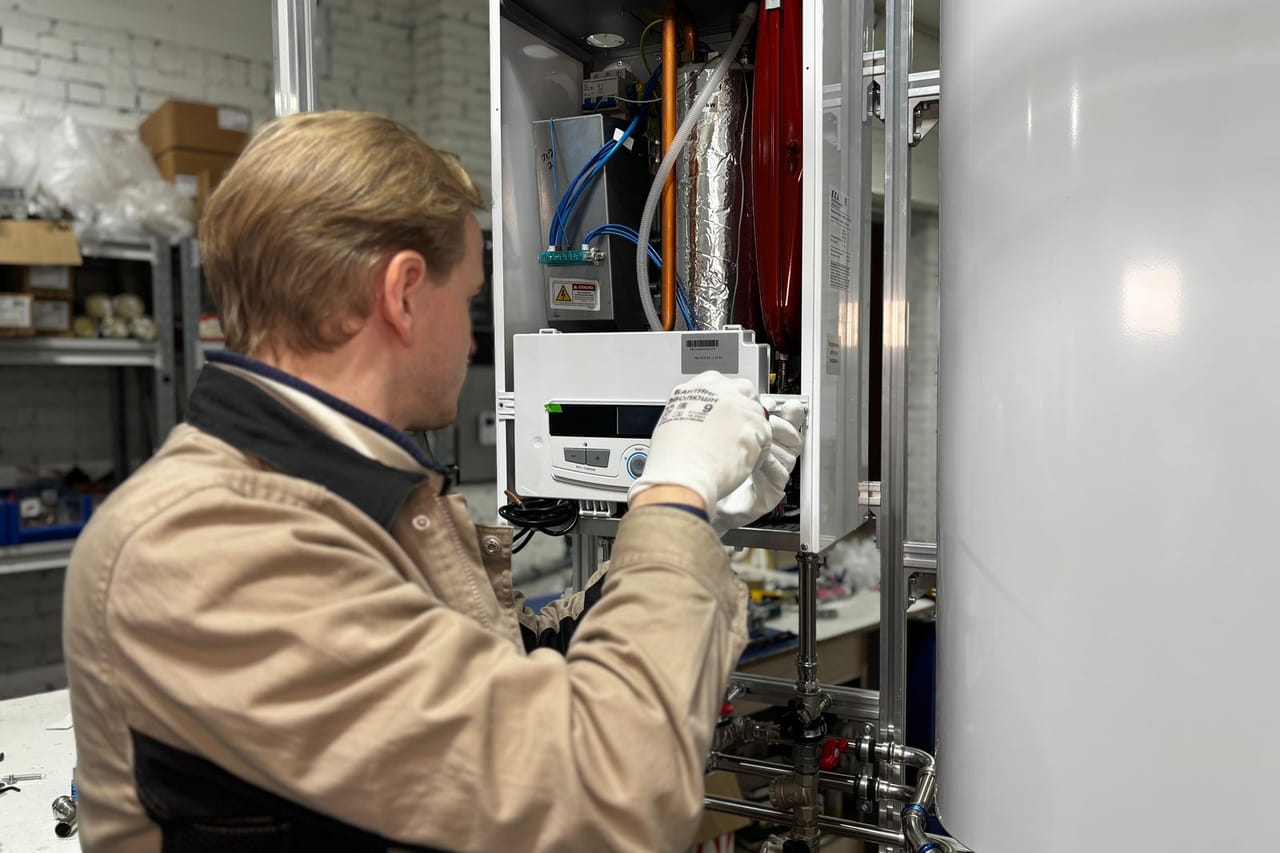 Plumber Grand Prairie TX: Technician repairing heating system in workshop
