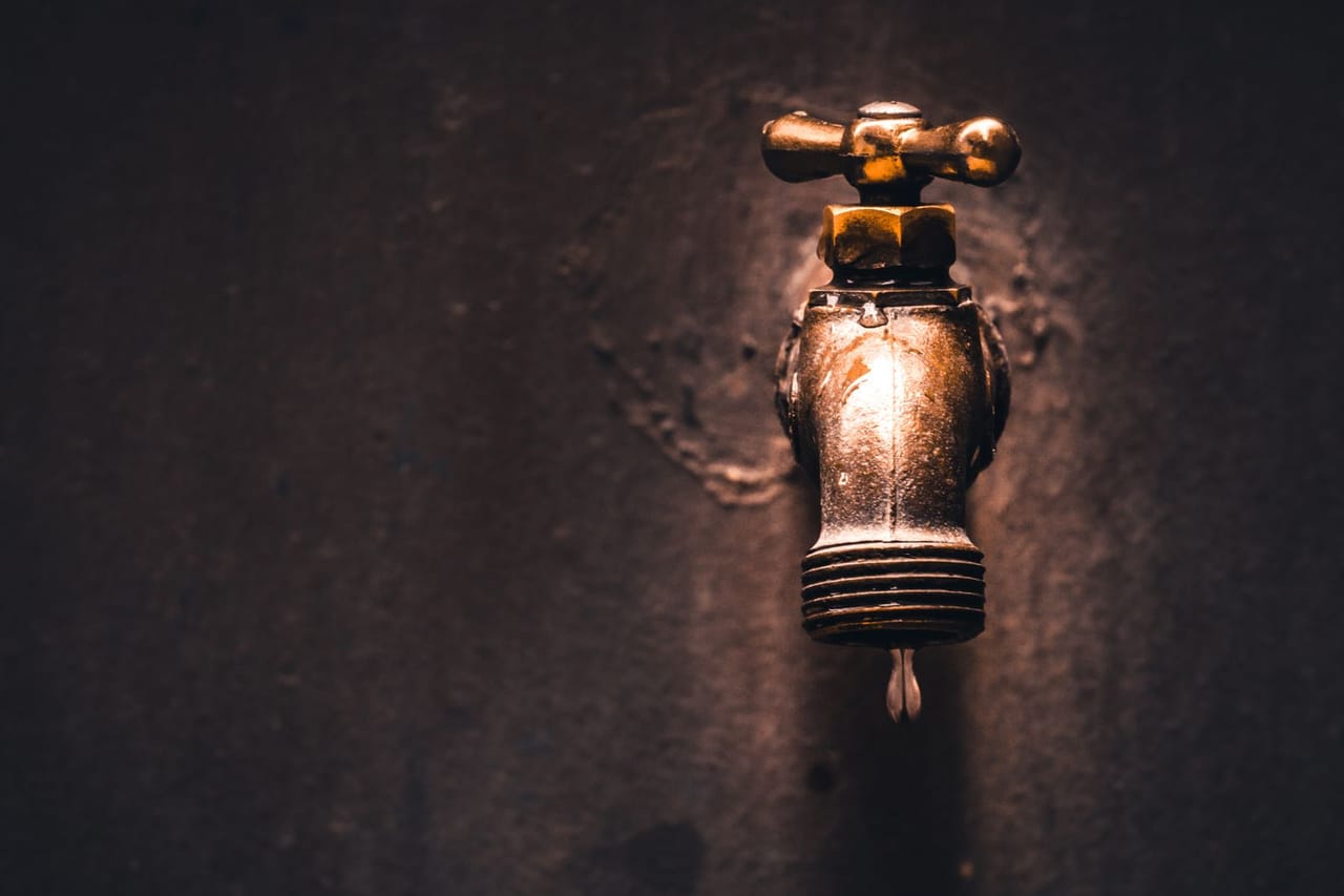 Plumber Gresham OR: Brass faucet with water droplet