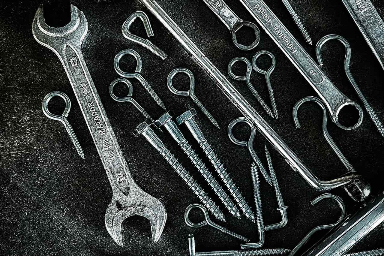 Plumber Las Cruces NM: Assorted metal tools on a dark surface