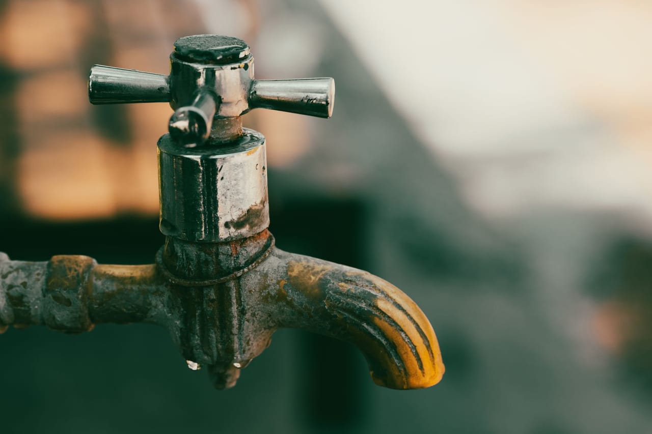 Plumber Palm Springs CA: A rusty metal faucet in close up photography