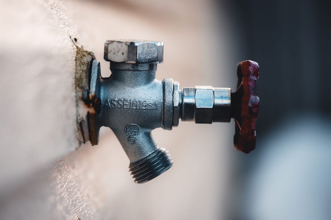 Plumber Peoria AZ: Close up of metal faucet on wall