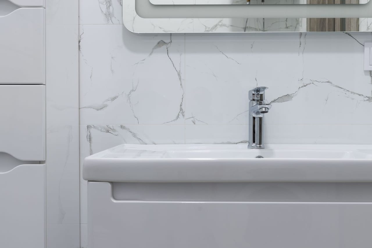 Plumber Providence RI: Washstand under mirror in contemporary bathroom at home