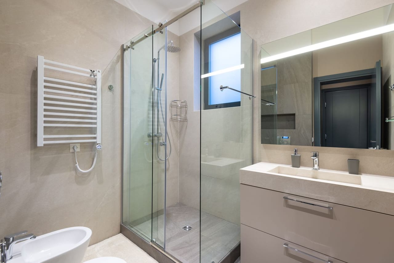 Plumber San Angelo TX: Interior of modern bathroom with glass shower cabin