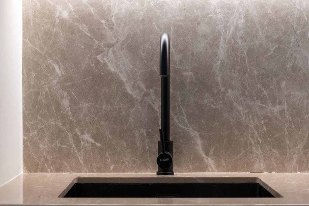 Plumber Sedalia MO: Modern kitchen sink with marble background