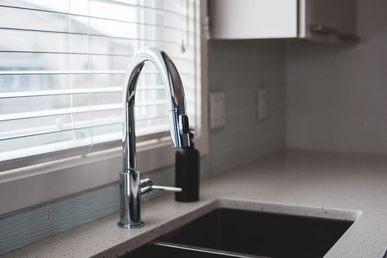 Plumber Shreveport LA: Stainless steel faucet near white window blinds