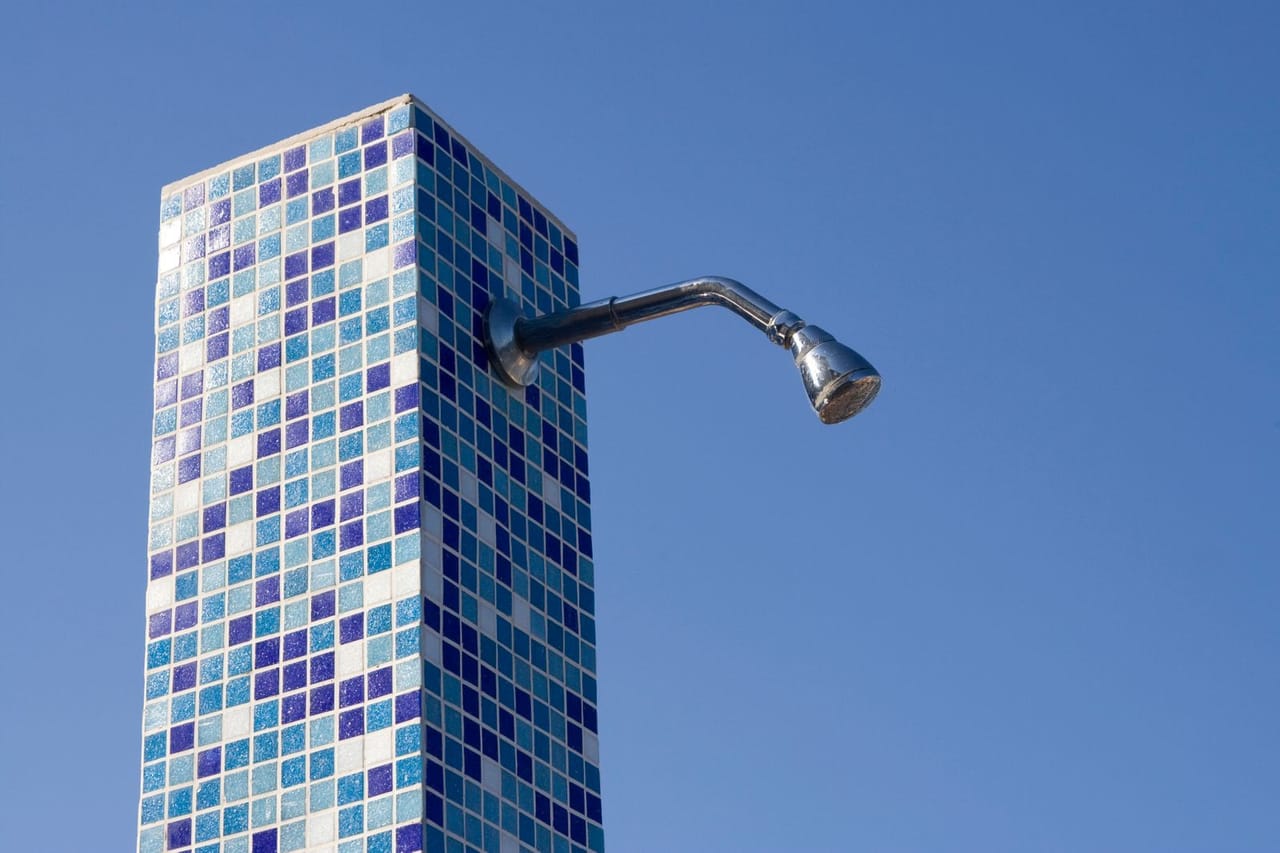 Plumber St Clair Shores MI: Outdoor tiled shower against blue sky