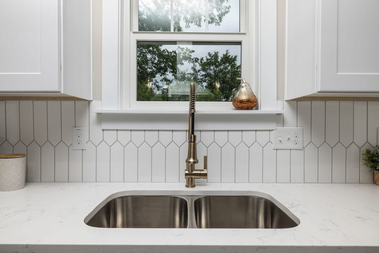 Plumber Syracuse NY: Stainless steel sink under a window