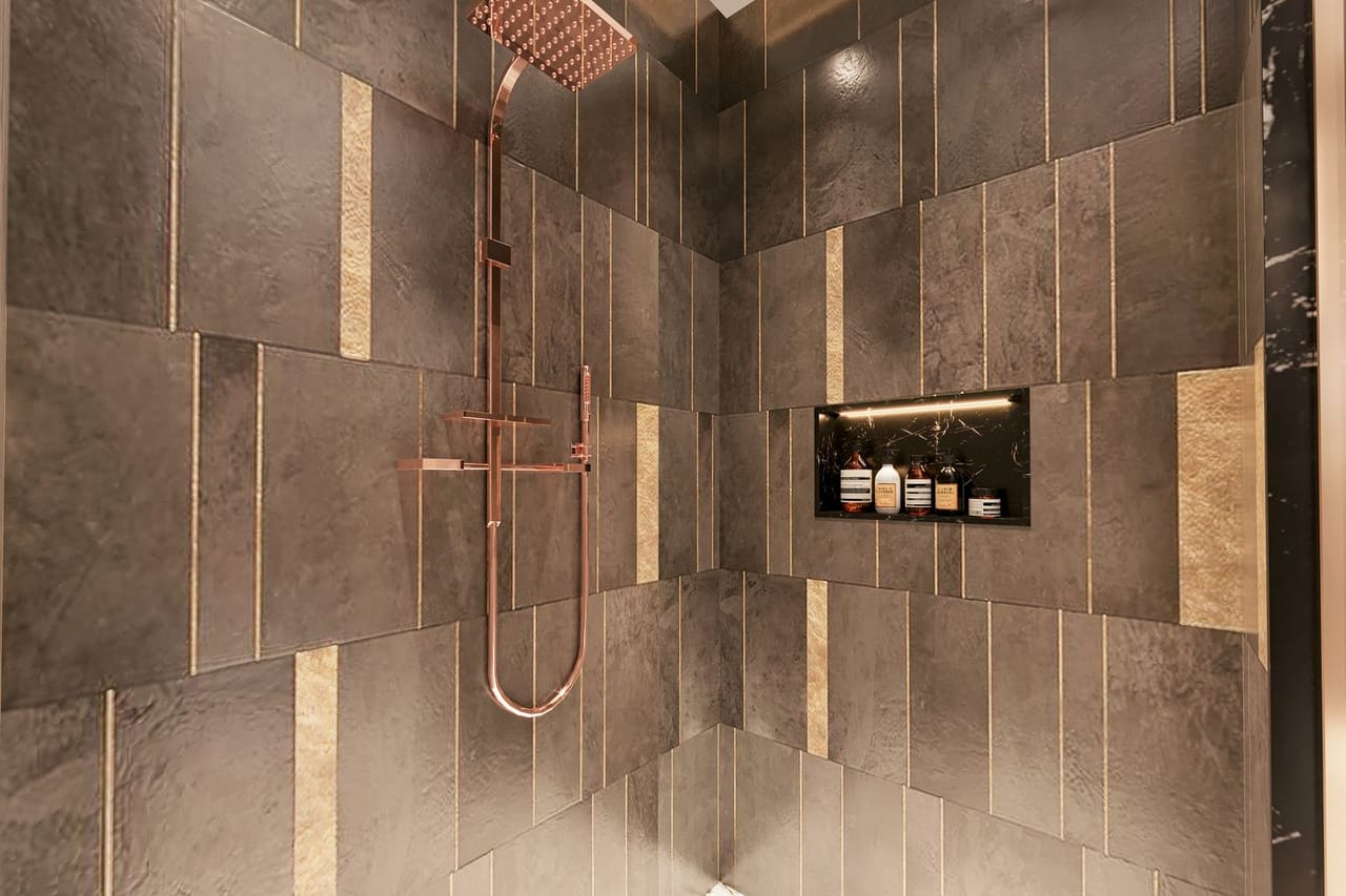 Plumber Texarkana TX: Elegant modern shower with dark tiles and copper fixtures