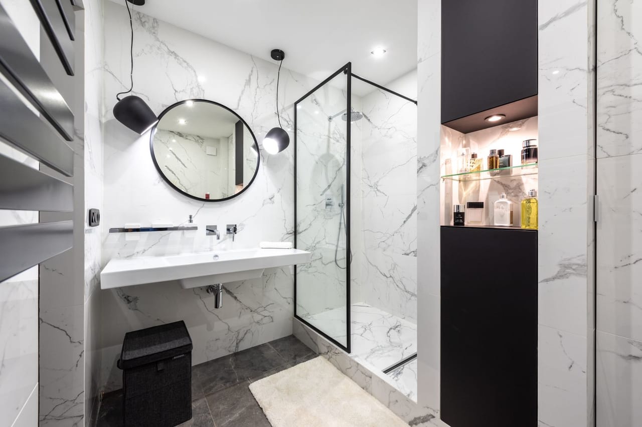 Plumber Virginia Beach VA: Modern bathroom interior with mirror between lamps at home