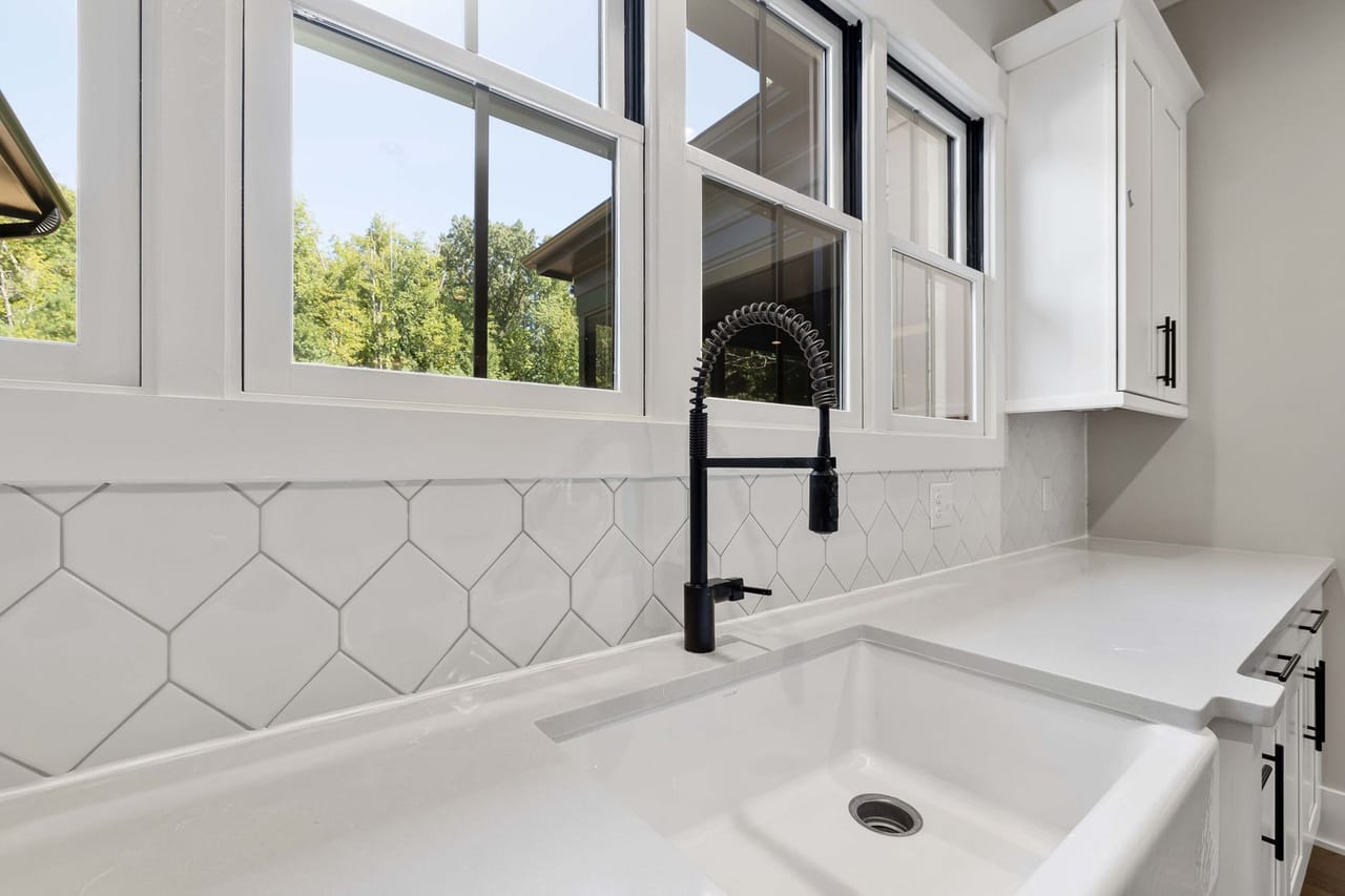 Plumber York PA: Black faucet on white ceramic sink