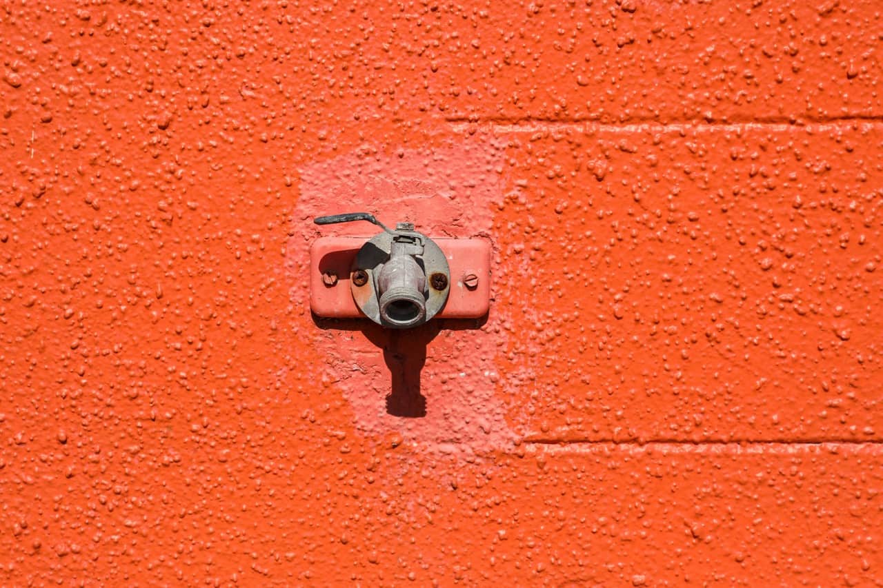 Plumber Zanesville OH: Faucet on orange wall