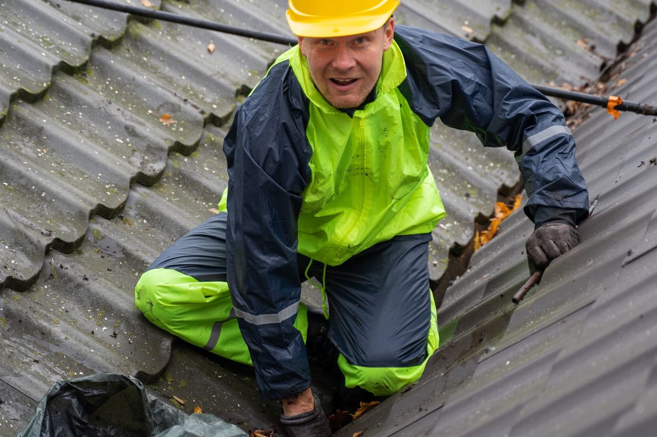 Roof repair Baltimore MD: Construction worker on the roof