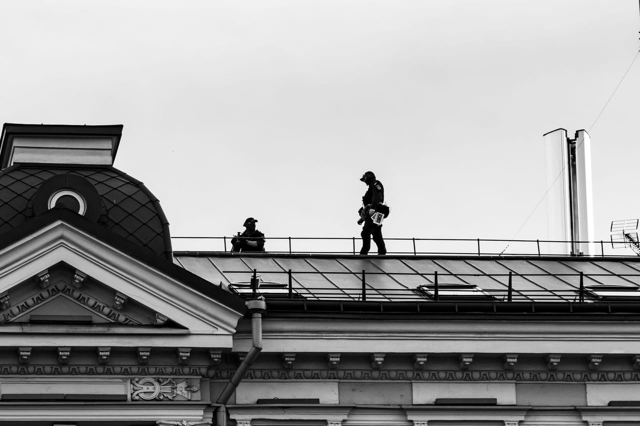 Roof repair Bangor ME: People walking on a roof
