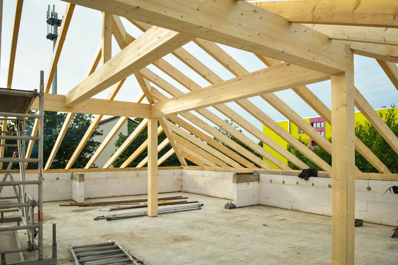 Roof repair Bloomington MN: Wooden frame of roof on concrete building