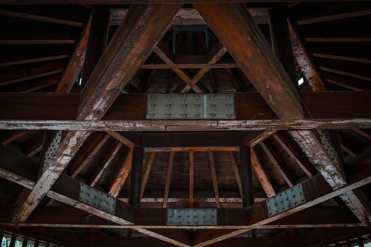 Roof repair Bridgeport CT: Intricate wooden roof truss structure artistry