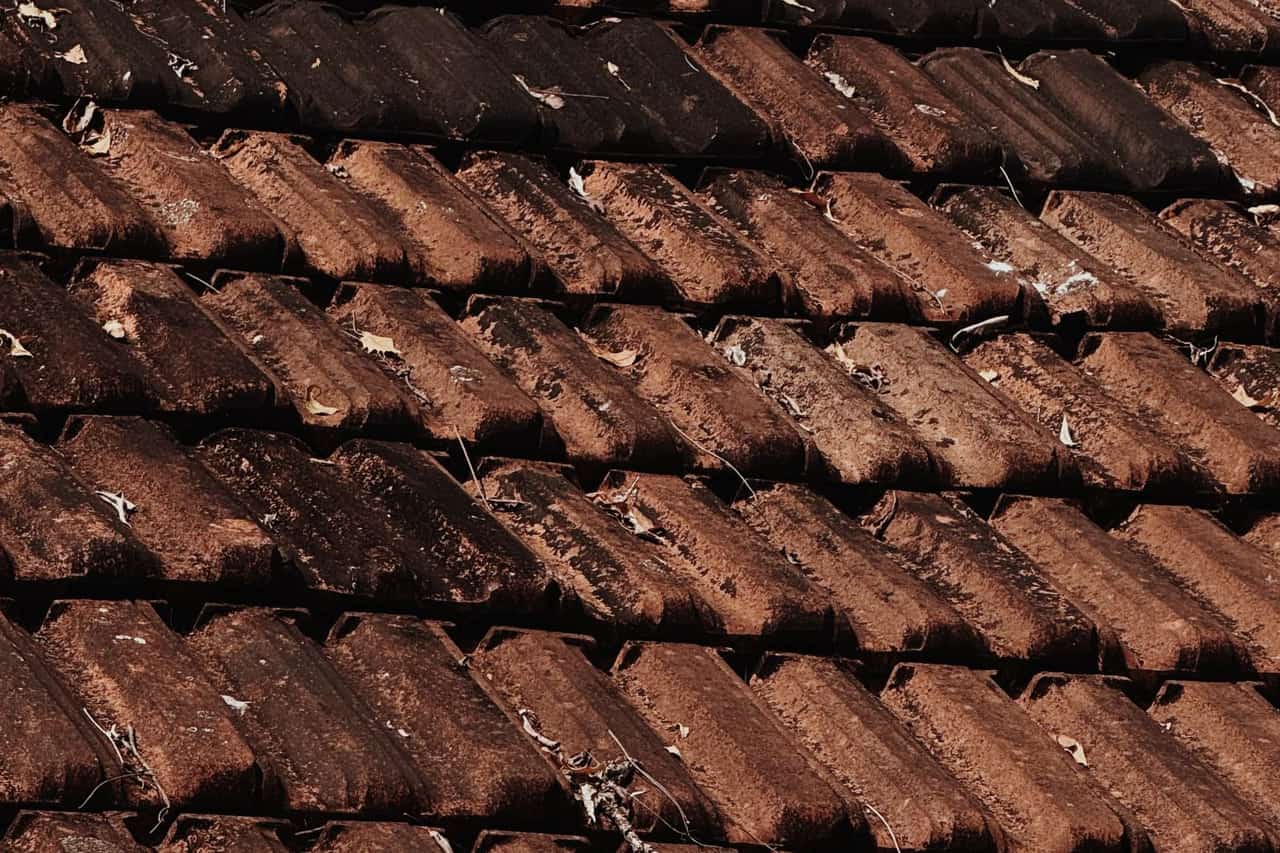 Roof repair Champaign IL: Rustic tiled roof with natural patina texture
