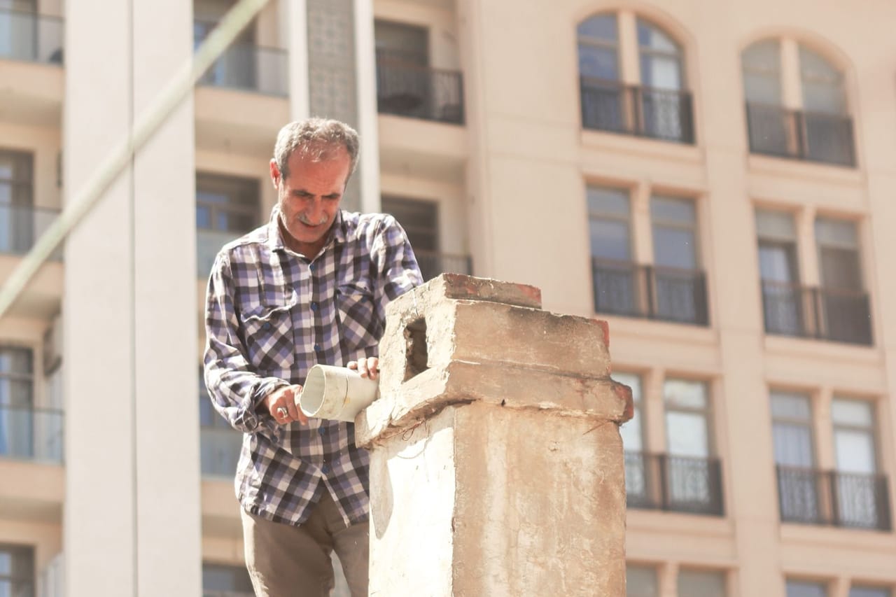 Roof repair College Station TX: Man in shirt working on roof