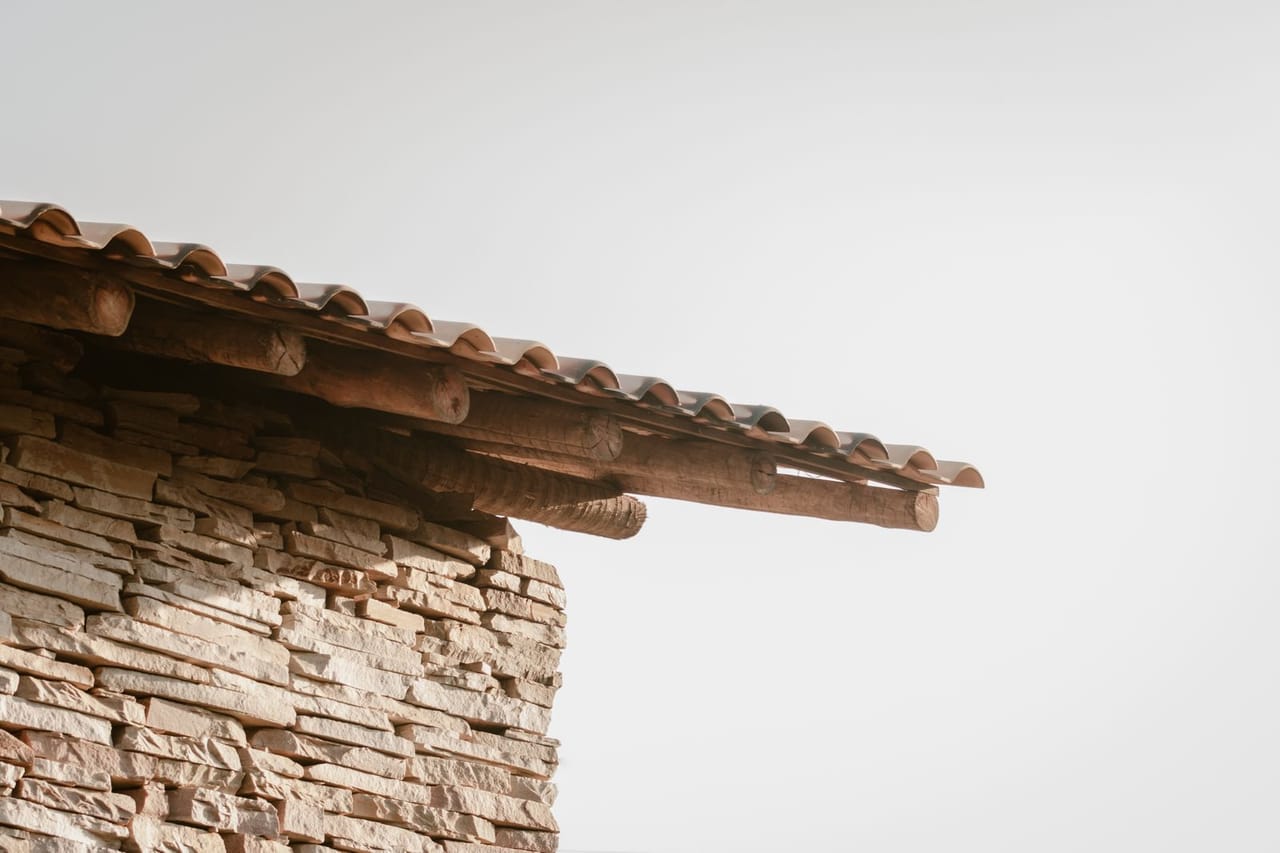 Roof repair Houma LA: Rustic stone and wood roof detail
