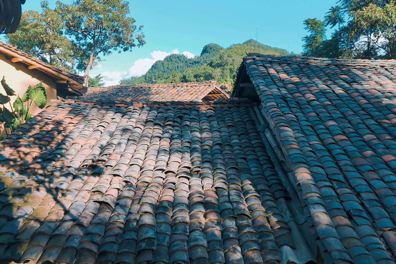 Roof repair Irving TX: A roof with tiled tiles and a mountain in the background