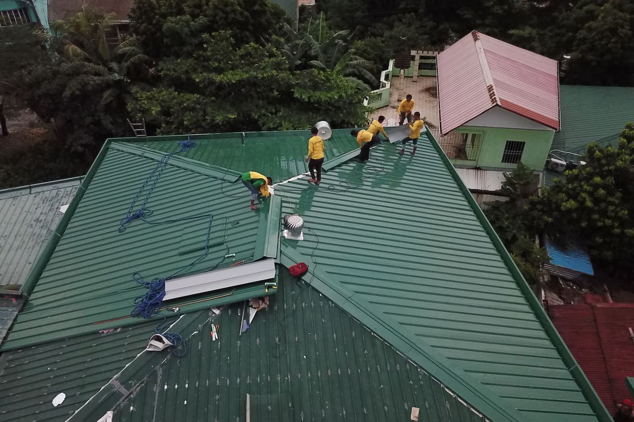 Roof repair Kent WA: People working on a house roof