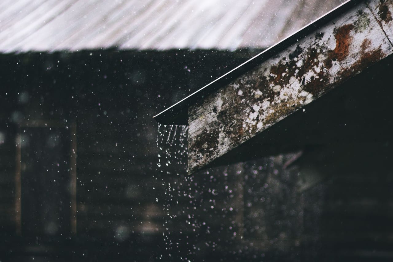 Roof repair Morro Bay CA: Selective focus photography of corrugated metal sheet of house during rainy daytime