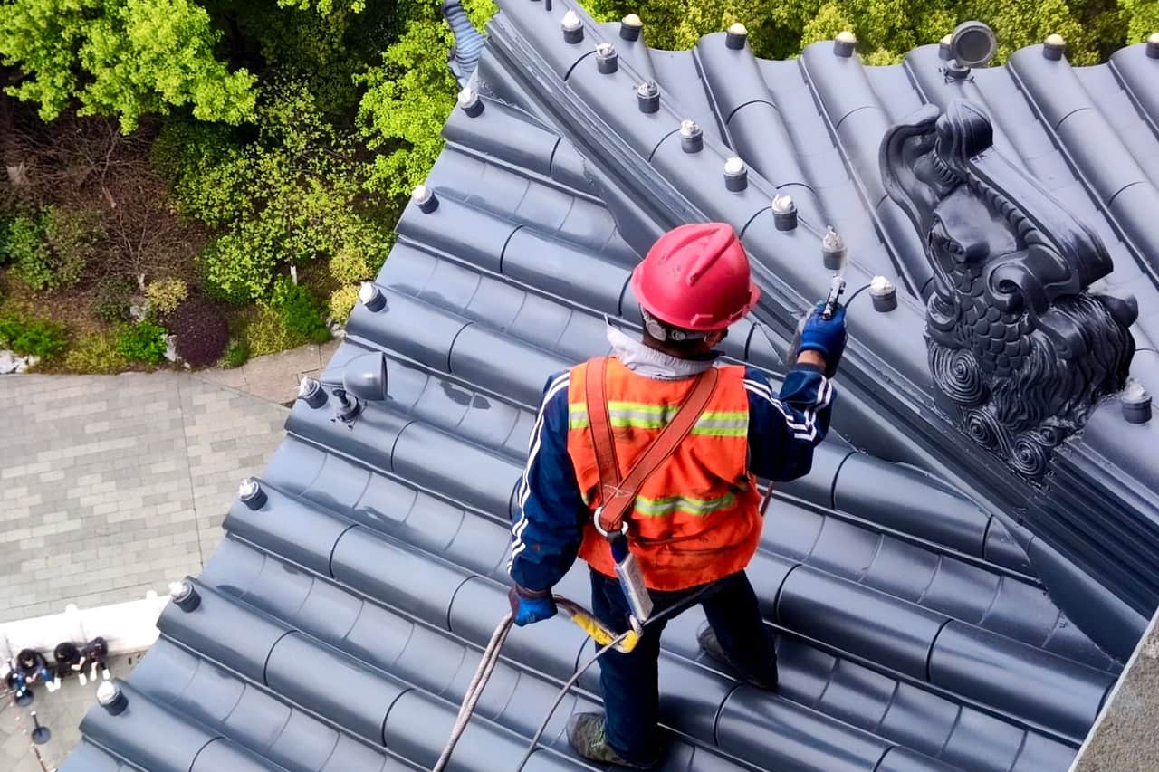 Roof repair Odessa TX: Man working on rooftop