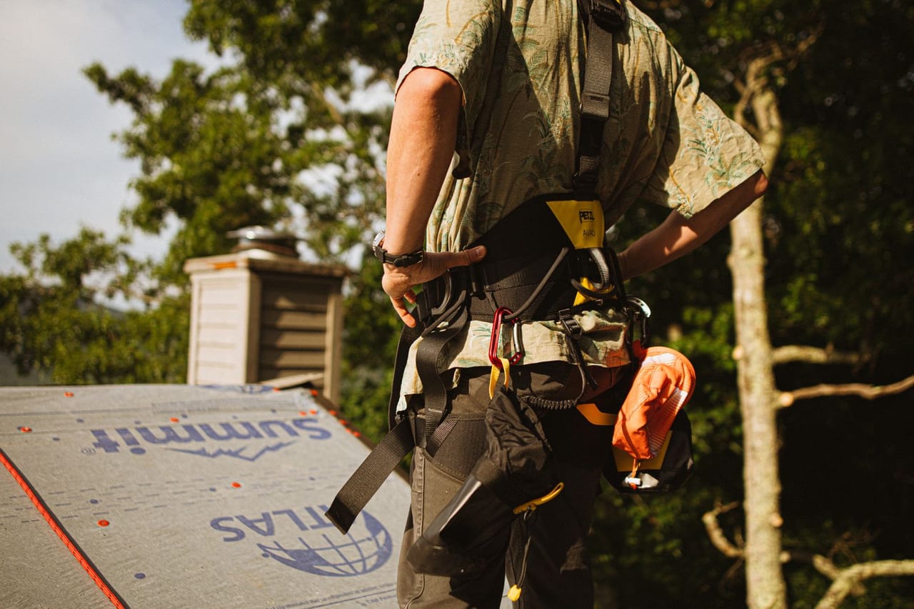Roof repair Raleigh NC: Roofer at work with safety gear