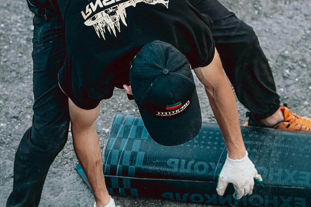 Roof repair Salem OR: Worker installing roofing material on construction site