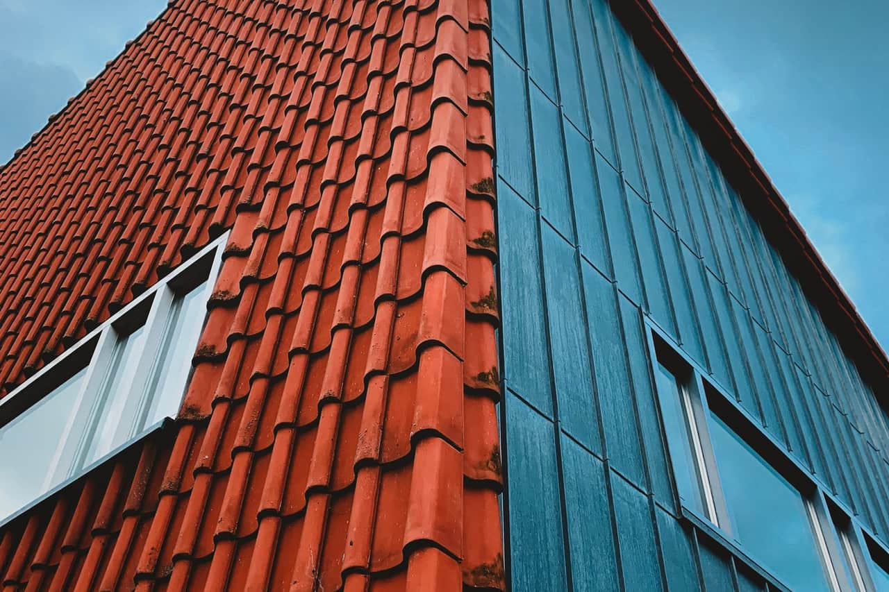 Roof repair San Antonio TX: Brick and wooden building against blue sky