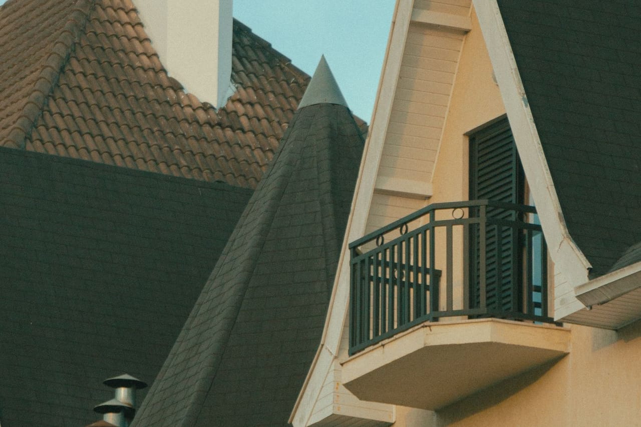 Roof repair San Bernardino CA: A house with balconies and a chimney