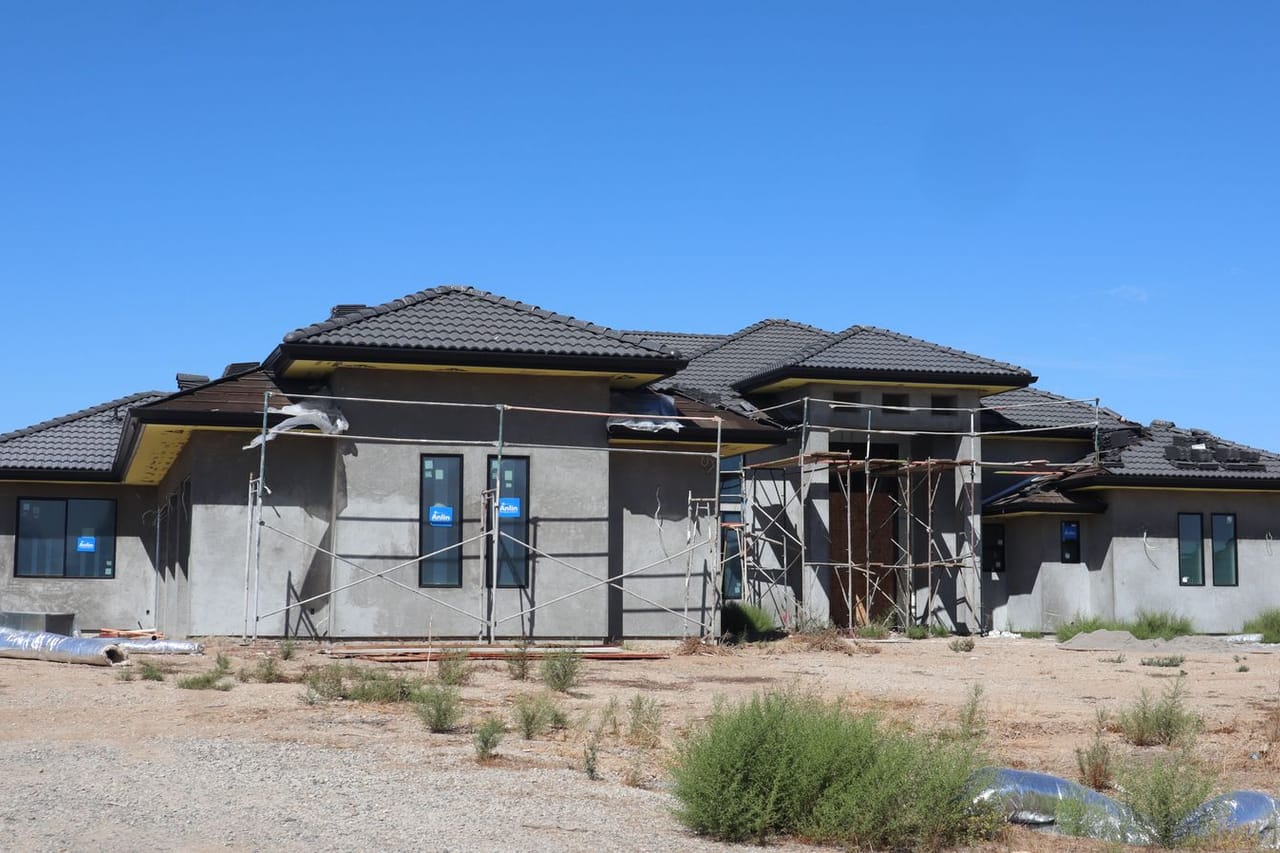 Roof repair San Diego CA: Modern house under construction with blue sky