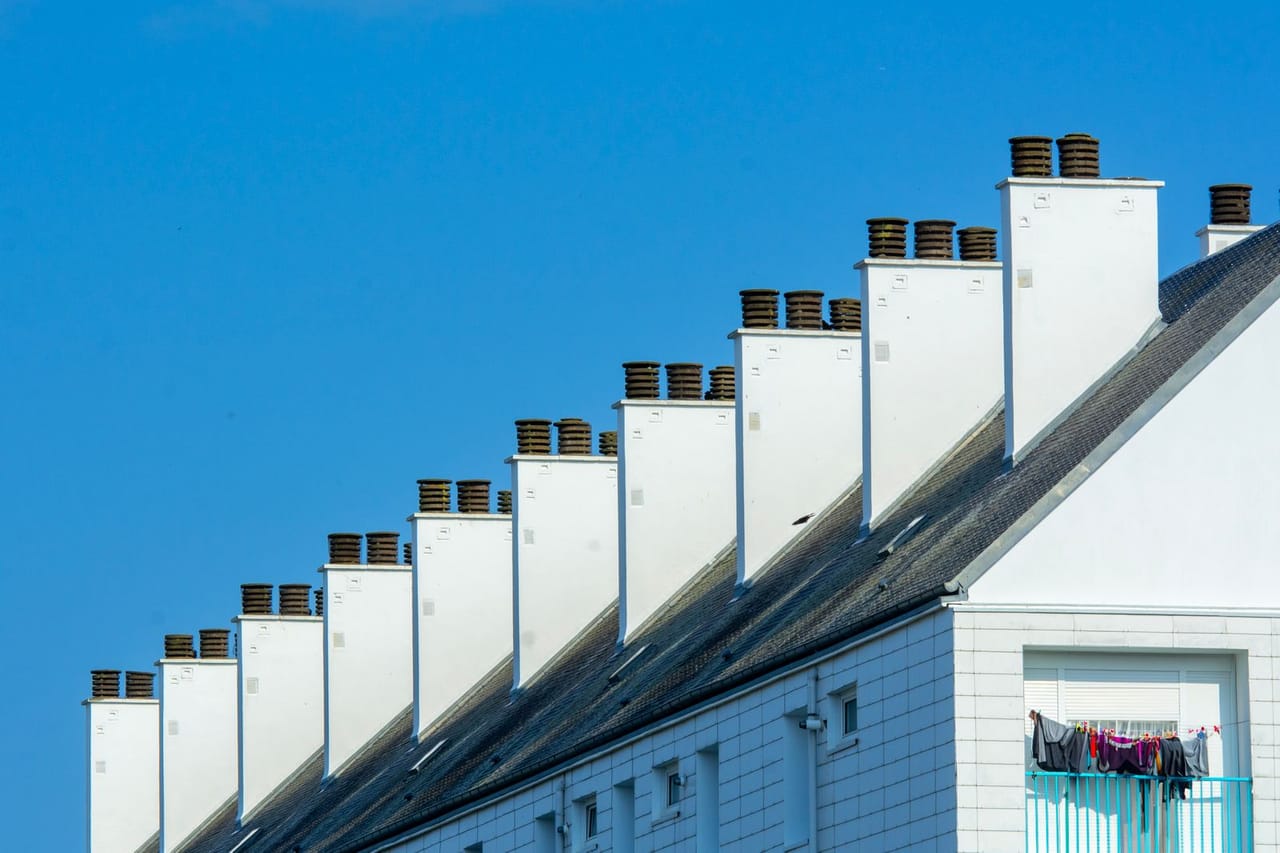 Roof repair Santa Clarita CA: Rooftop with chimneys of residential building