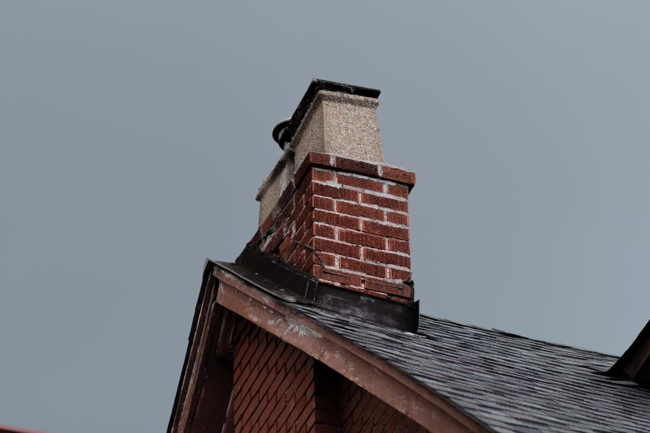Roof repair Schaumburg IL: Low angle shot of a house with a chimney