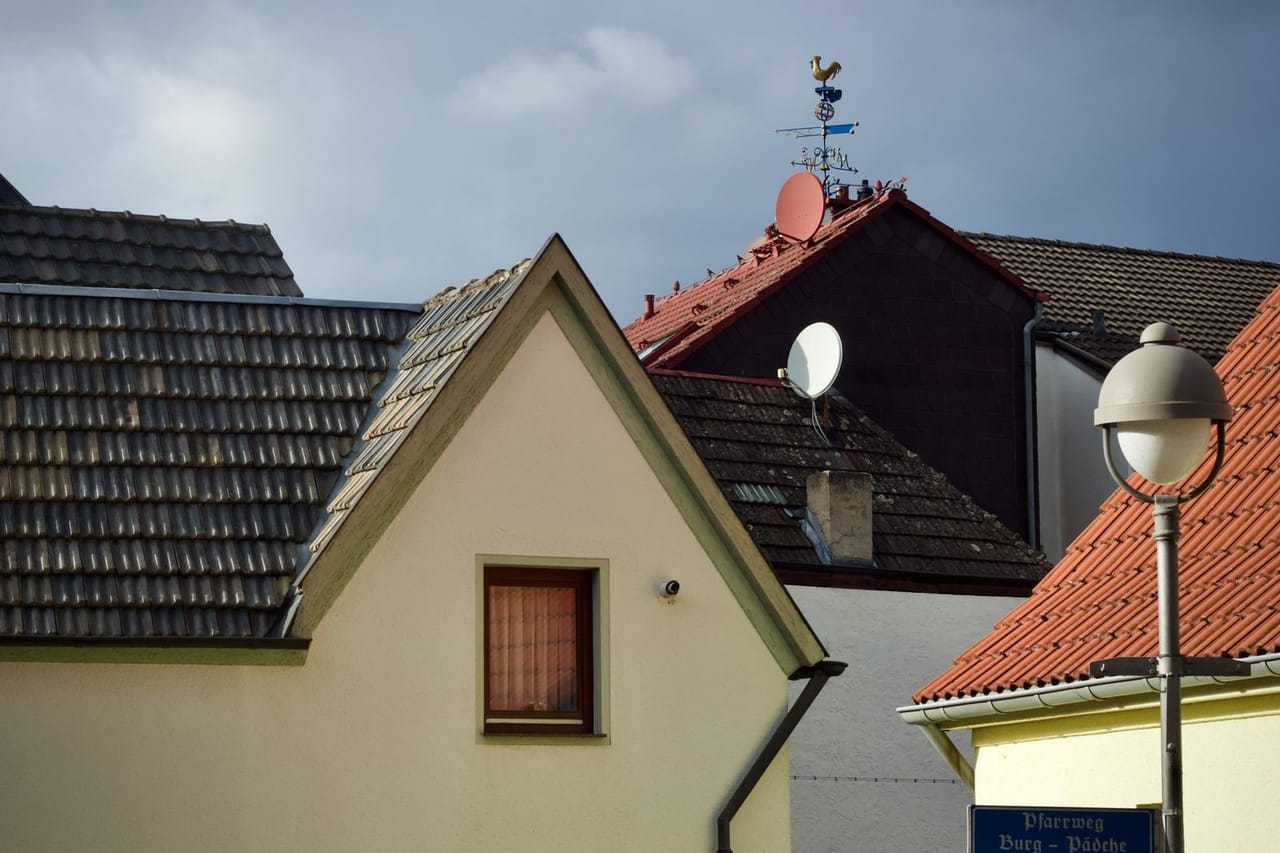 Roof repair Shreveport LA: Charming european rooftops with satellite dishes