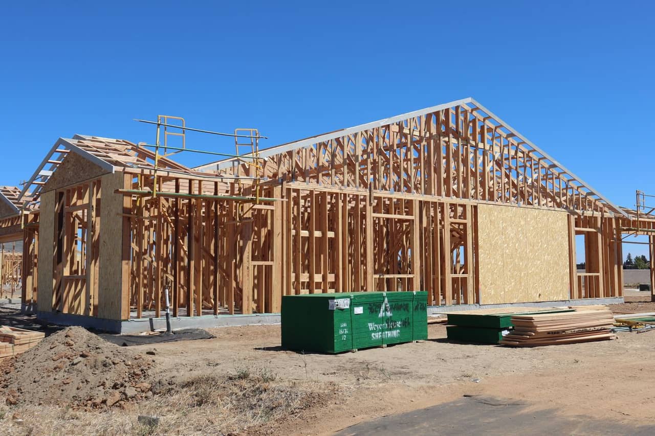 Roof repair Somerset NJ: Wooden house frame under construction in sunlight