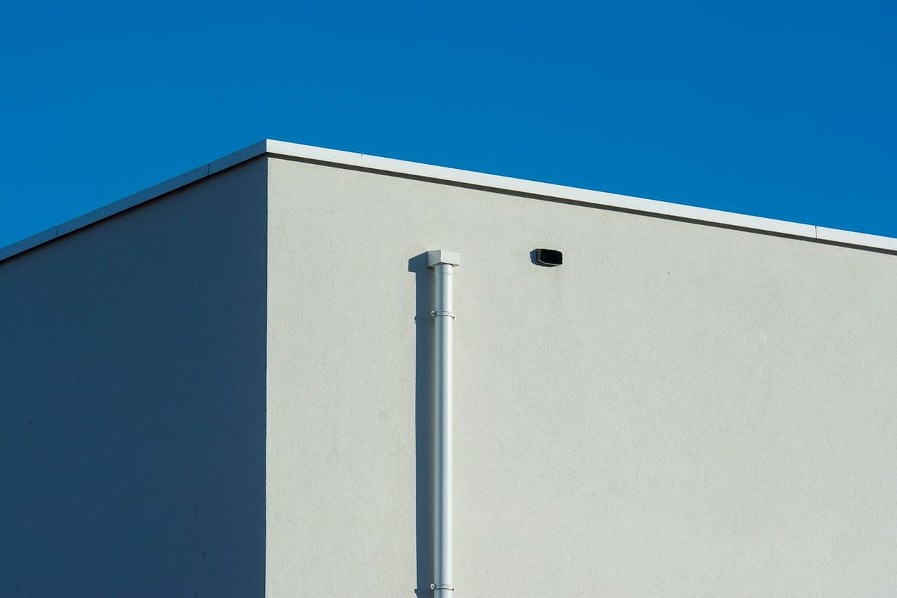 Roof repair Stillwater OK: Gutter on sunlit building wall