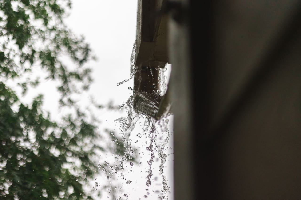 Roof repair Stockton CA: Water on the gutter in macro shot photography