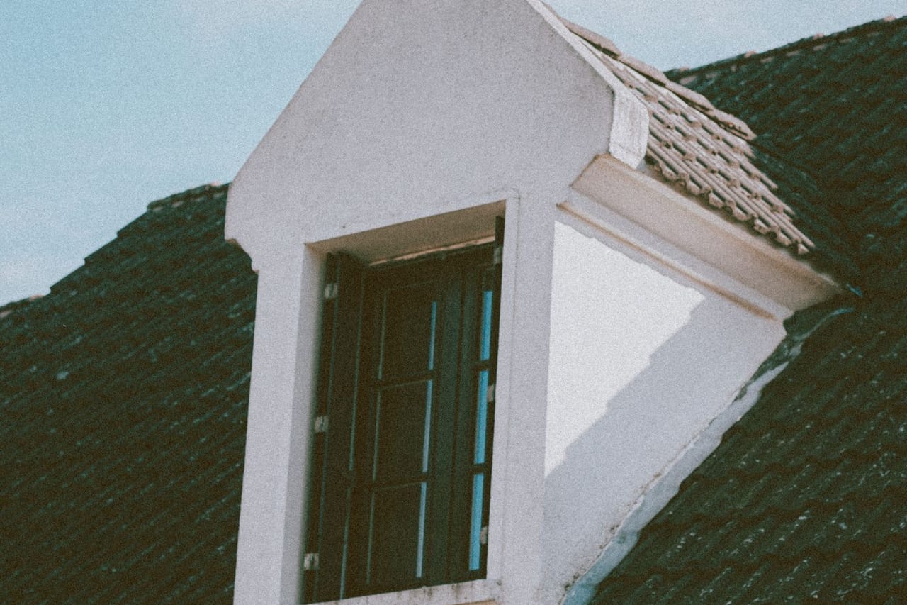 Roof repair Topeka KS: Details of residential house with mansard window