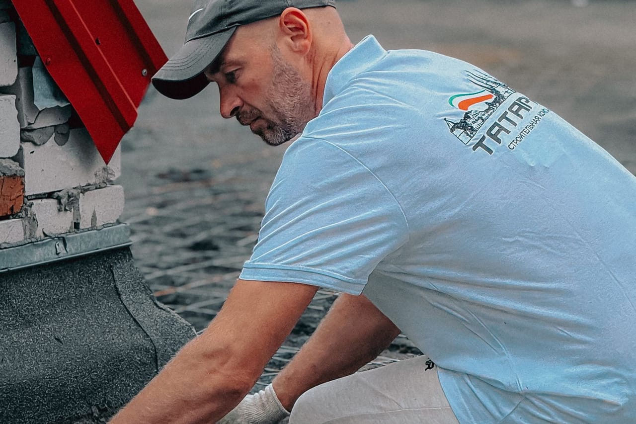 Roof repair Victoria TX: Professional roofer working on tar surface
