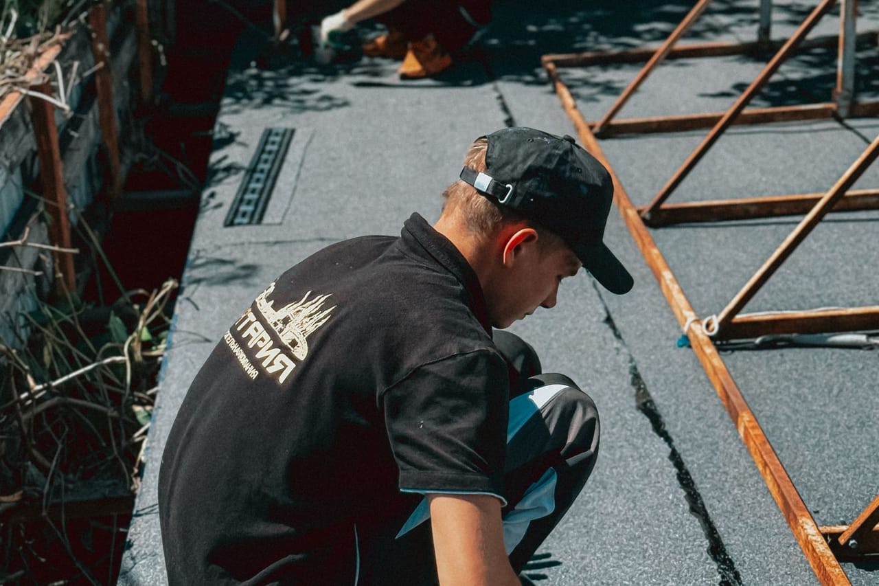 Roof repair Virginia Beach VA: Roofing contractors installing waterproofing membrane