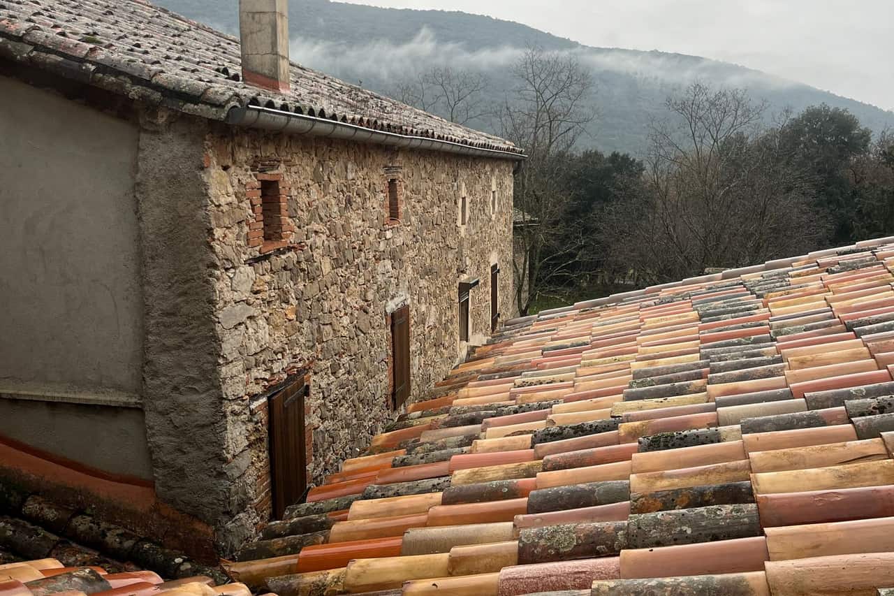 Roof repair Yakima WA: Rustic stone house with colorful rooftop view