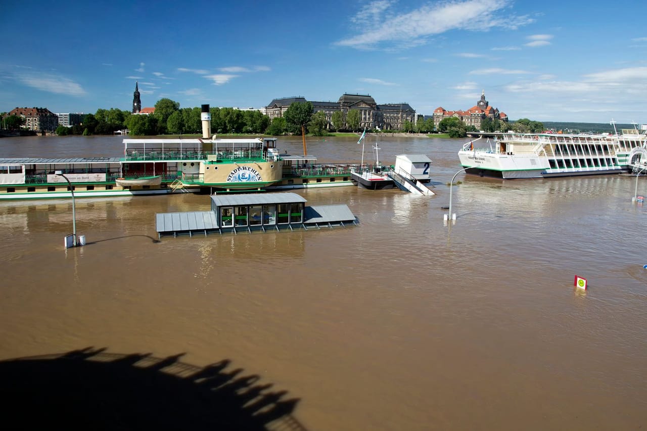 Water damage restoration Concord NH: Flooded river with docked boats under blue sky