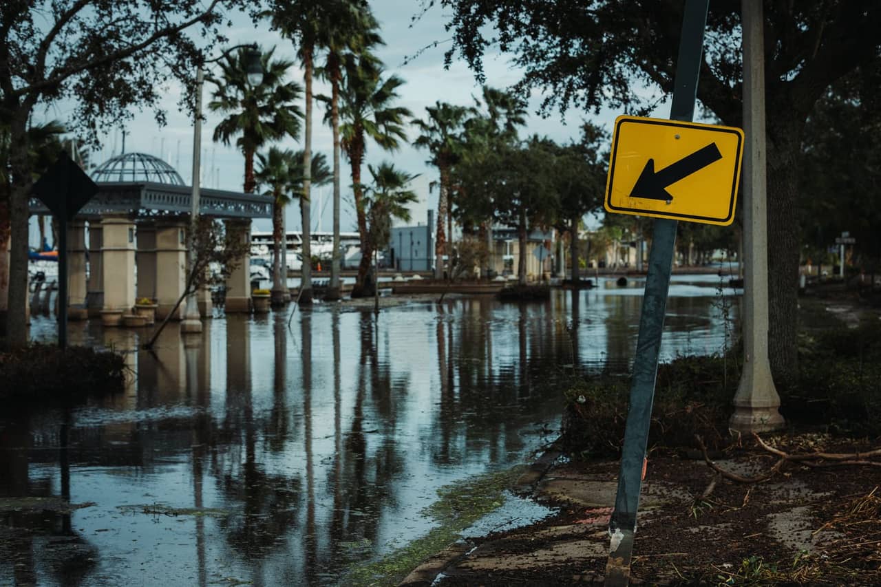 Water damage restoration Fairbanks AK: A street sign near the flooded road
