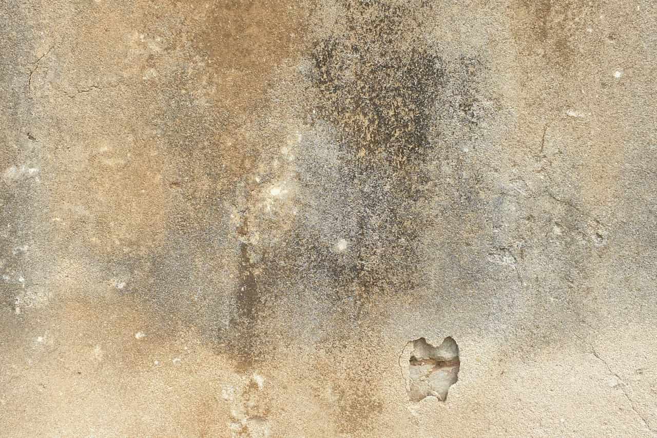 Water damage restoration in Houston: Textured weathered wall surface with cracks