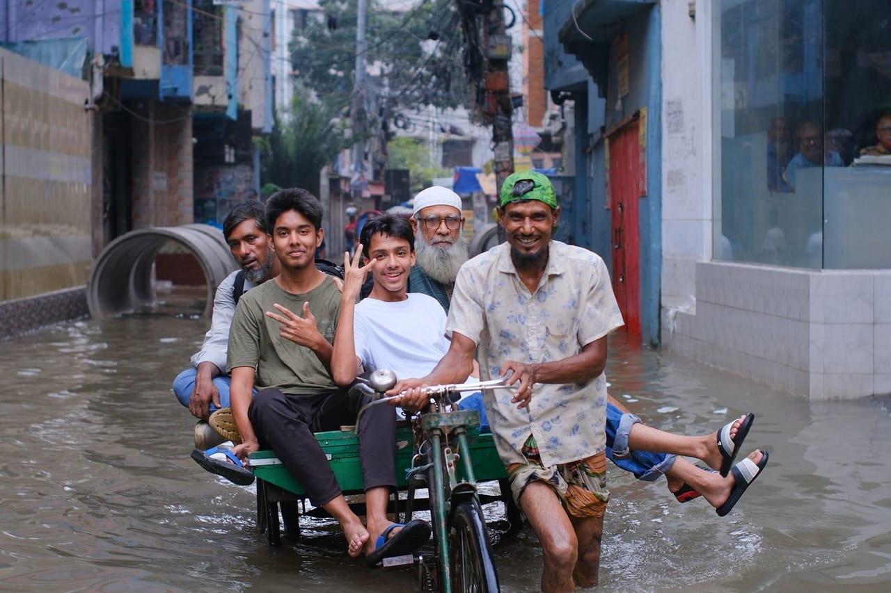Water damage restoration in Miami: Flooded street with rickshaw and passengers