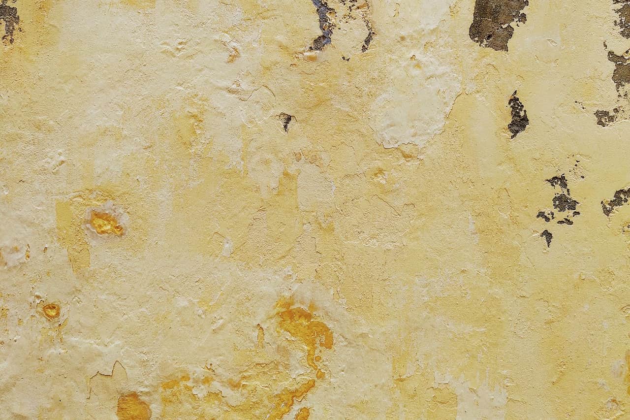 Water damage restoration Napa CA: Yellow paint peeling off on concrete wall